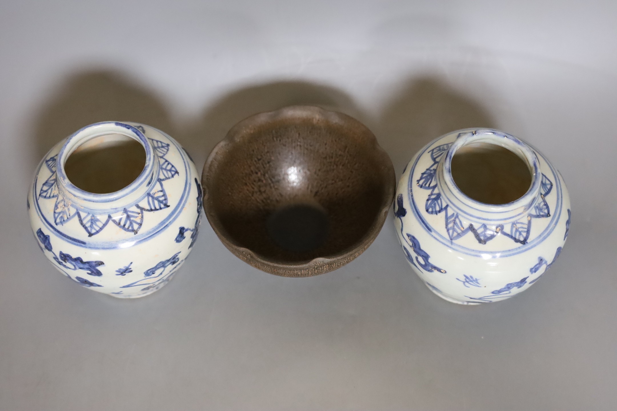 A Chinese jun type hares fur bowl and pair of blue and white vases, 12cm